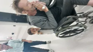 Oscar pushing Michael in wheelchair with Tar at Hospital in Perth