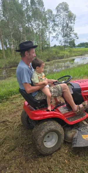 Michael and Oscar on ride-on mower